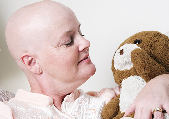 woman recovering from cancer with teddy bear