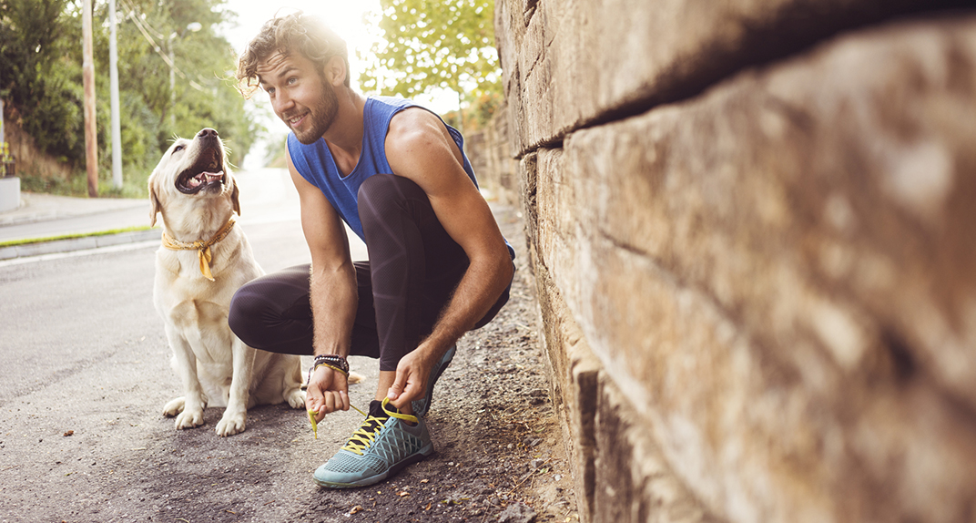 man running with dog