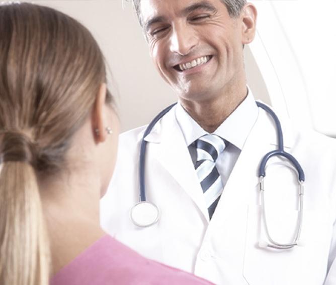 doctor assisting diagnosis of woman in pink