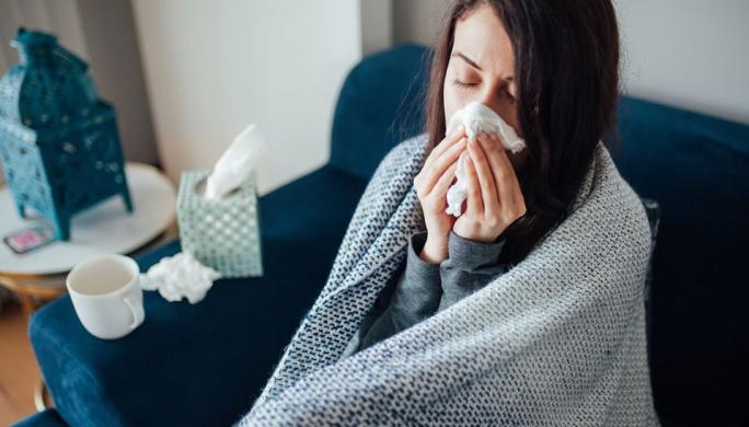 Sick Woman Blowing Nose