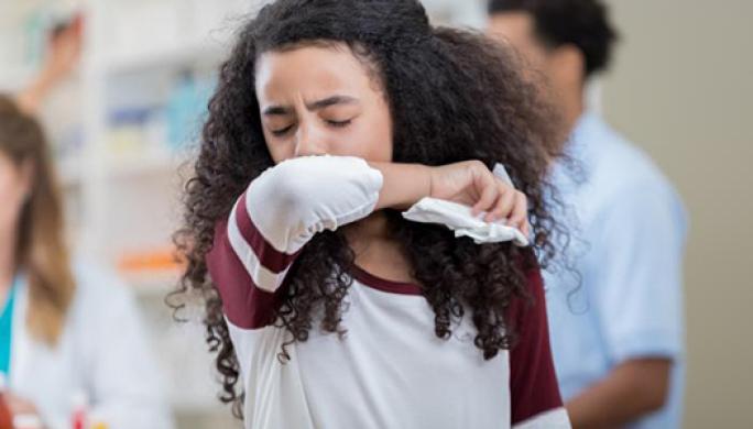 Girl covering her mouth