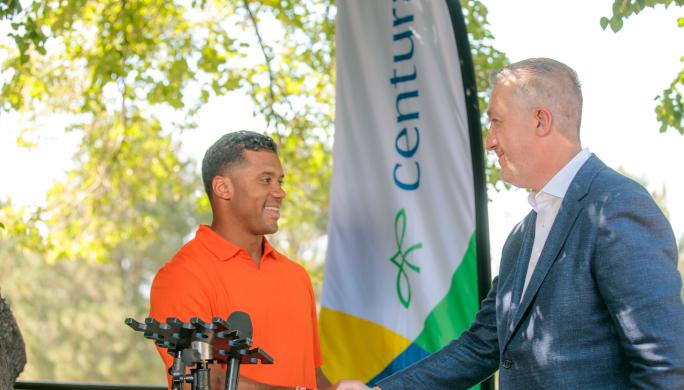 Peter D. Banko and Russell Wilson shake hands