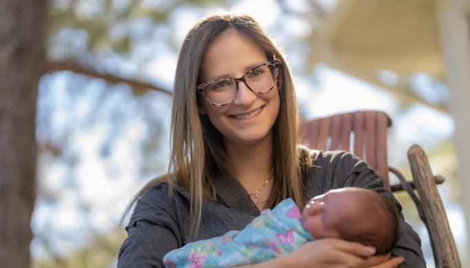 A woman holding her newborn daughter, at home, in Centennial Colorado, September 23, 2022.