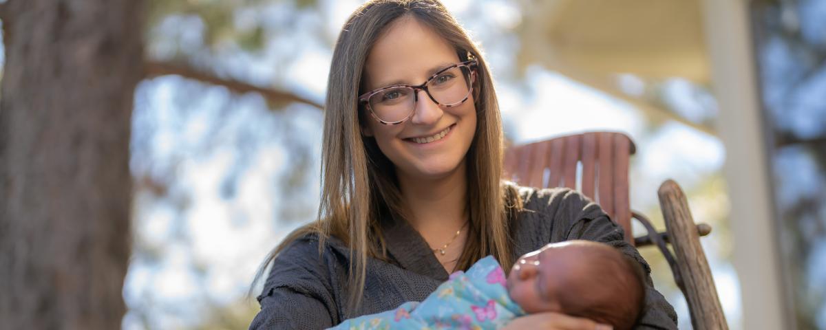 A woman holding her newborn daughter, at home, in Centennial Colorado, September 23, 2022.