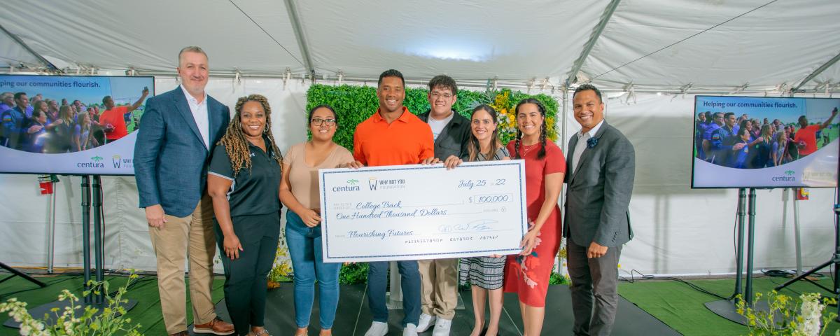 Peter Banko, Centura Staff, and Russell Wilson hold check